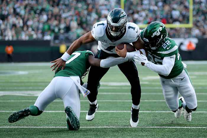 Philadelphia Eagles quarterback Jalen Hurts (1) is tackled by New York Jets cornerback Bryce Hall (37) and safety Tony Adams (22) during the first quarter at MetLife Stadium.